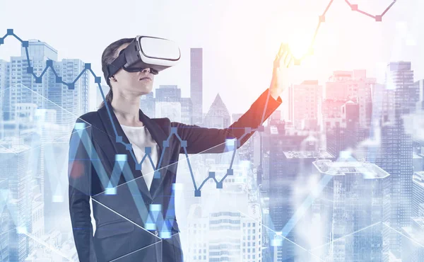 Woman in VR glasses working with graph in city — Stock Photo, Image
