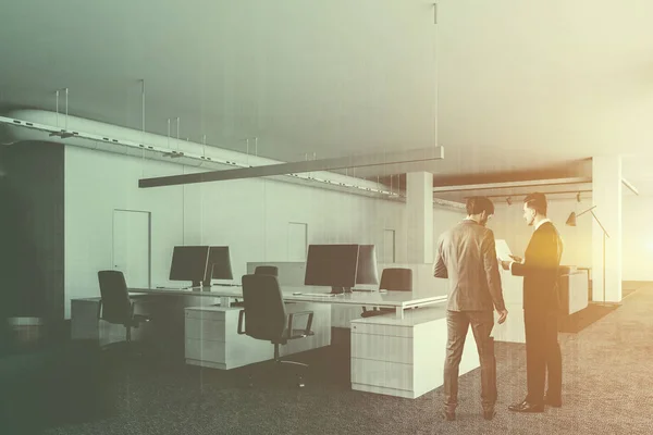 People in white office corner with columns