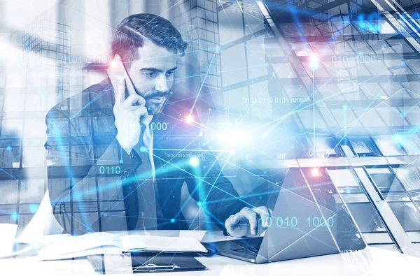 Man with laptop at office table, binary code