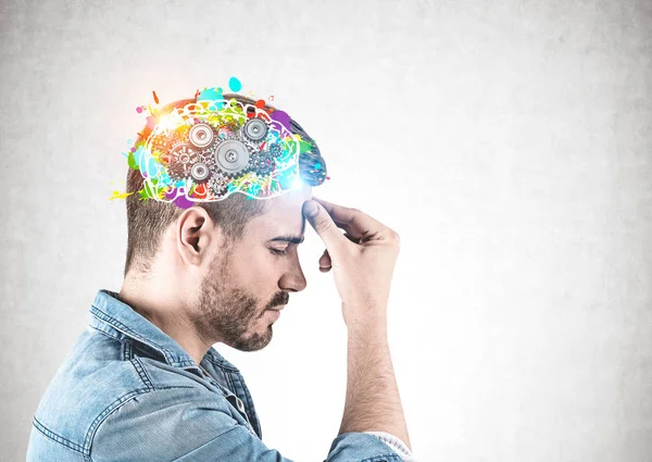 Side view of casual man thinking, cog brain Stock Photo