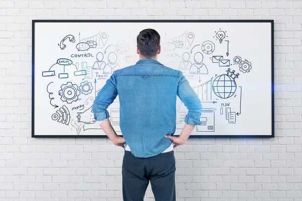 Man looking at business plan sketch — Stock Photo, Image