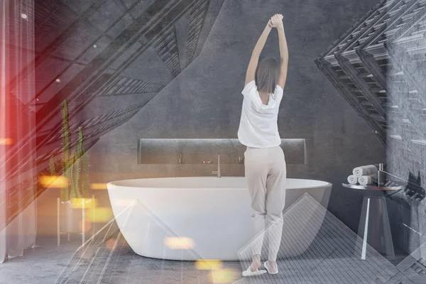 Vrouw in concrete badkamer interieur met bad — Stockfoto