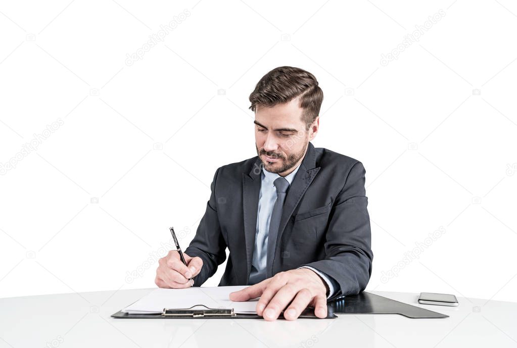Business man in suit signing a contract or some papers
