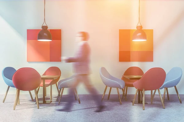 Man walking in red cafe interior