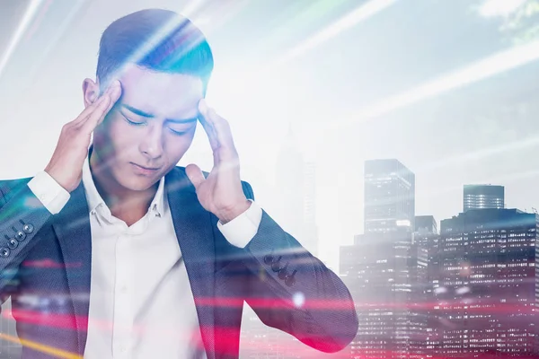 Stressed Asian businessman in city — Stock Photo, Image