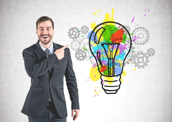 Happy man in suit showing idea sketch — Stock Photo, Image