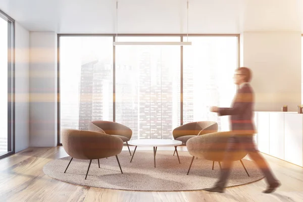 Stock image Man walking in office lounge