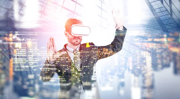 Businessman in VR glasses in city, skyscraper — Stock Photo, Image