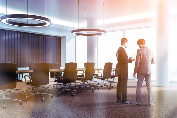 Businessmen in black meeting room