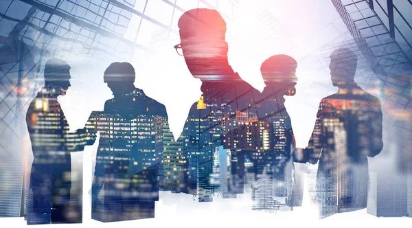Business people collaborating, night skyscrapers — Stock Photo, Image