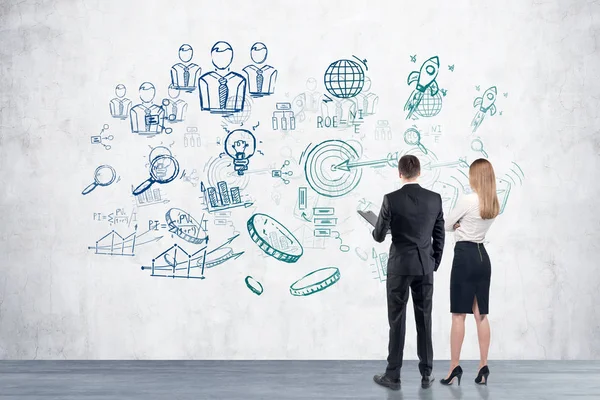 Man and woman looking at startup idea sketch — Stock Photo, Image