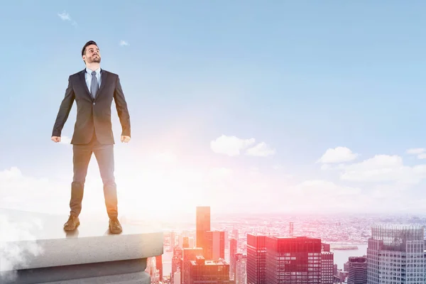 Confident businessman standing on city roof — Stock Photo, Image