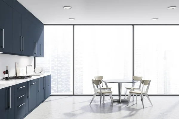 Белая панорамная кухня, синие прилавки и стол — стоковое фото