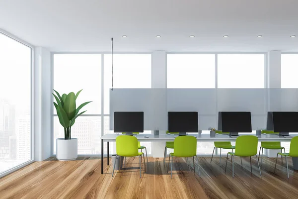 Open space office interior with green chairs