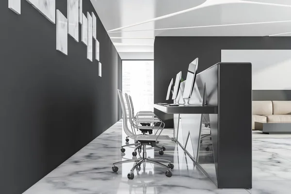 Side view of reception desk in black office lobby