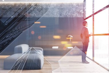 Takım elbiseli adam minimalist oturma odası penceresinde görünüyor