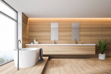 Küvetli ahşap banyo ve çift lavabo.