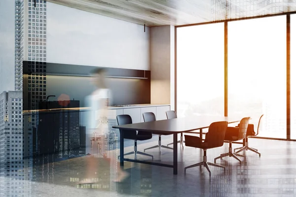 Woman walking in loft kitchen with big table — Stock Photo, Image