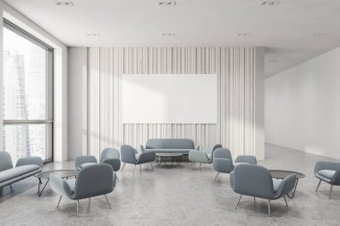 Beyaz ofis bekleme odası posterli ve kanepeli.