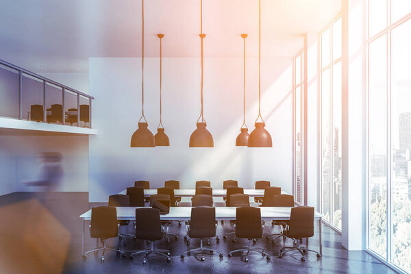 Man walking in two storey white open space office