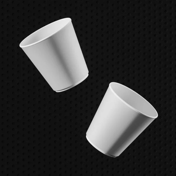 Две белые бумажные чашки на черном фоне — стоковое фото