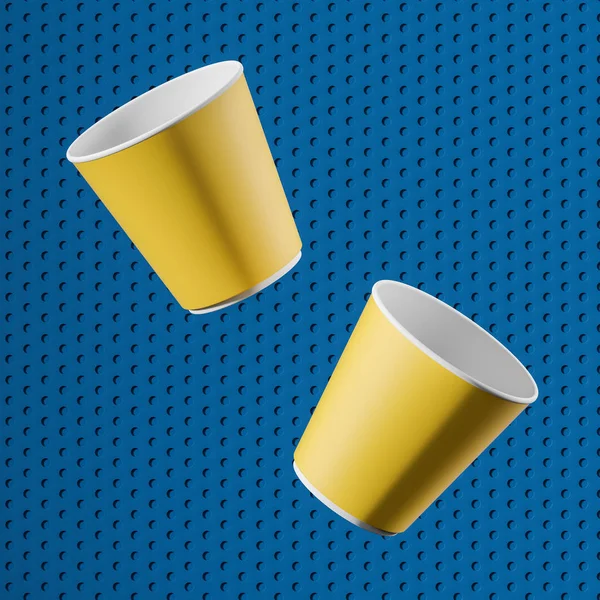 Mavi arka plan üzerinde iki sarı kağıt bardak — Stok fotoğraf