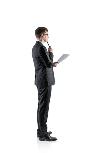 Pensive young businessman with document — Stock Photo, Image