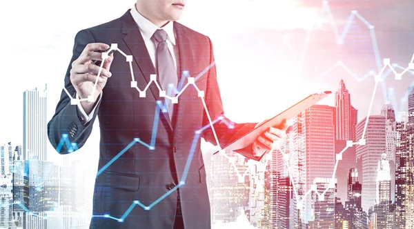 Businessman drawing graph in city — Stock Photo, Image