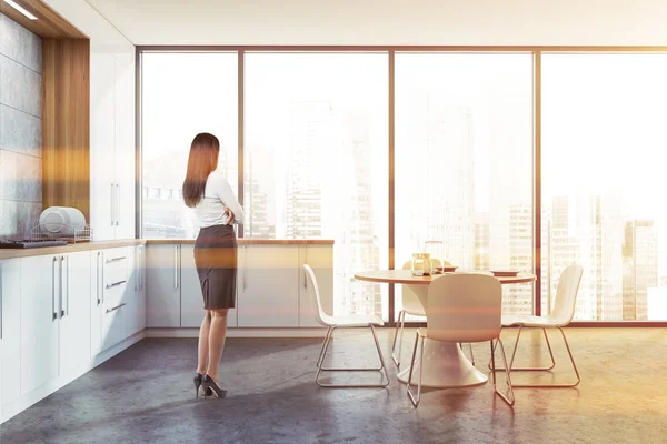 Donkerharige vrouw in witte keuken — Stockfoto