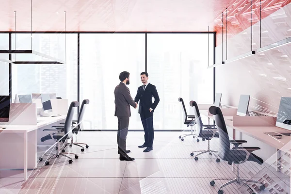 Businessmen shaking hands in orange office