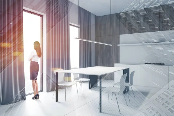 Woman in white and wooden kitchen corner