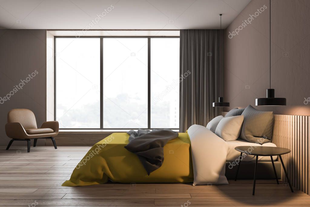Brown bedroom with yellow bed and armchair