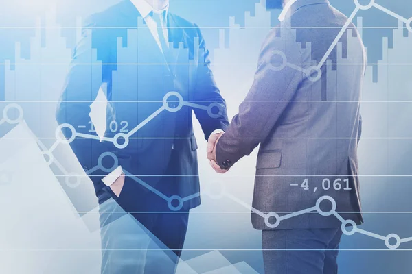 Two businessmen shaking hands, graphs — Stock Photo, Image