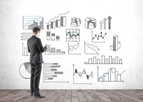 Man with document looking at business infographics — Stock Photo, Image