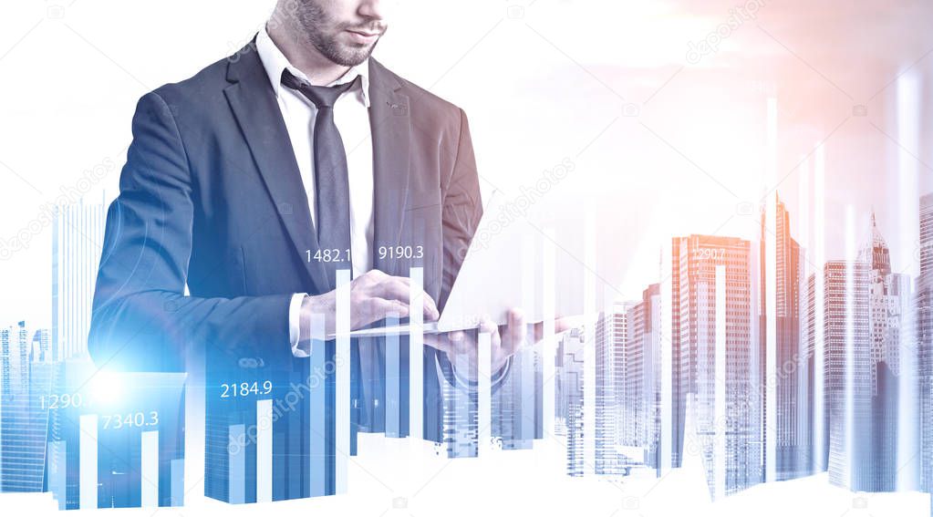 Businessman with laptop, HUD and graphs