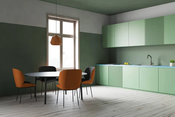 Зеленый кухонный уголок, зеленые прилавки и стол — стоковое фото