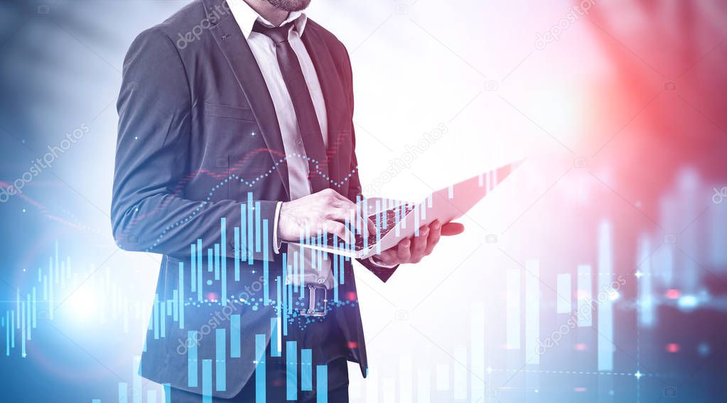 Man with laptop and graphs