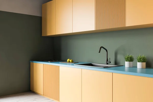 Green kitchen with yellow countertops — Stock Photo, Image