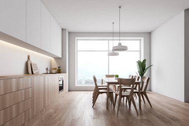 Masa ile beyaz mutfak yan görünümü