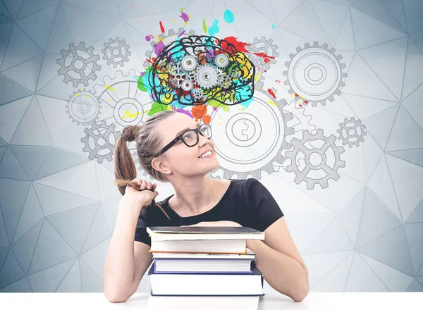 Smiling schoolgirl with books thinking hard — Stock Photo, Image