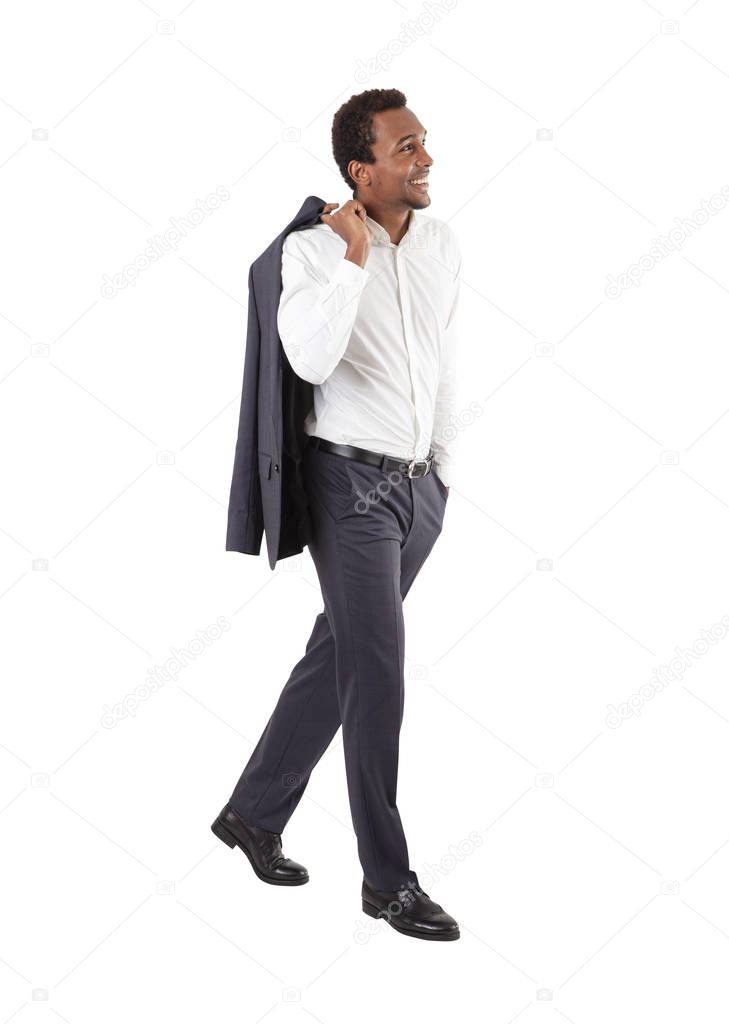 Smiling African American businessman walking