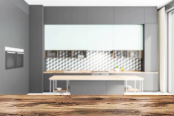 Blurred gray and blue kitchen interior with island