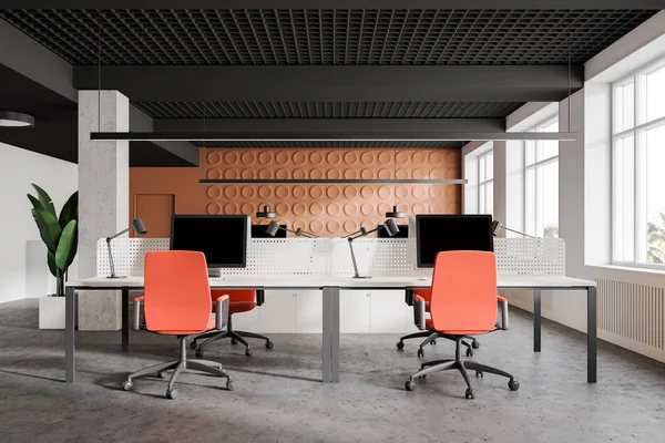 Bright orange and white open space office, columns
