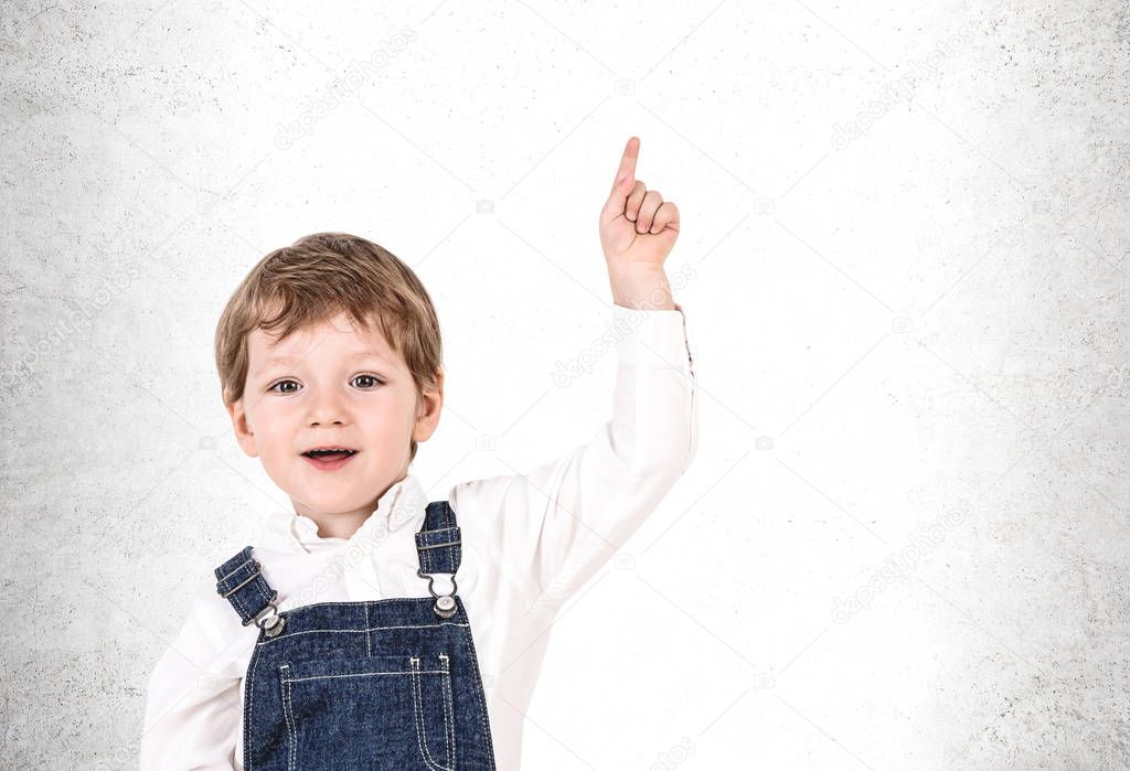 Adorable little boy pointing upwards, mock up