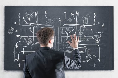 Kara tahtada iş planına bakan adam