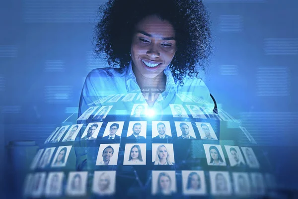 Smiling African woman looking at social media — Stock Photo, Image