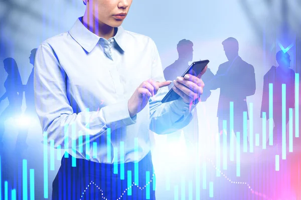 Woman using smartphone and business team, graphs — Stock Photo, Image
