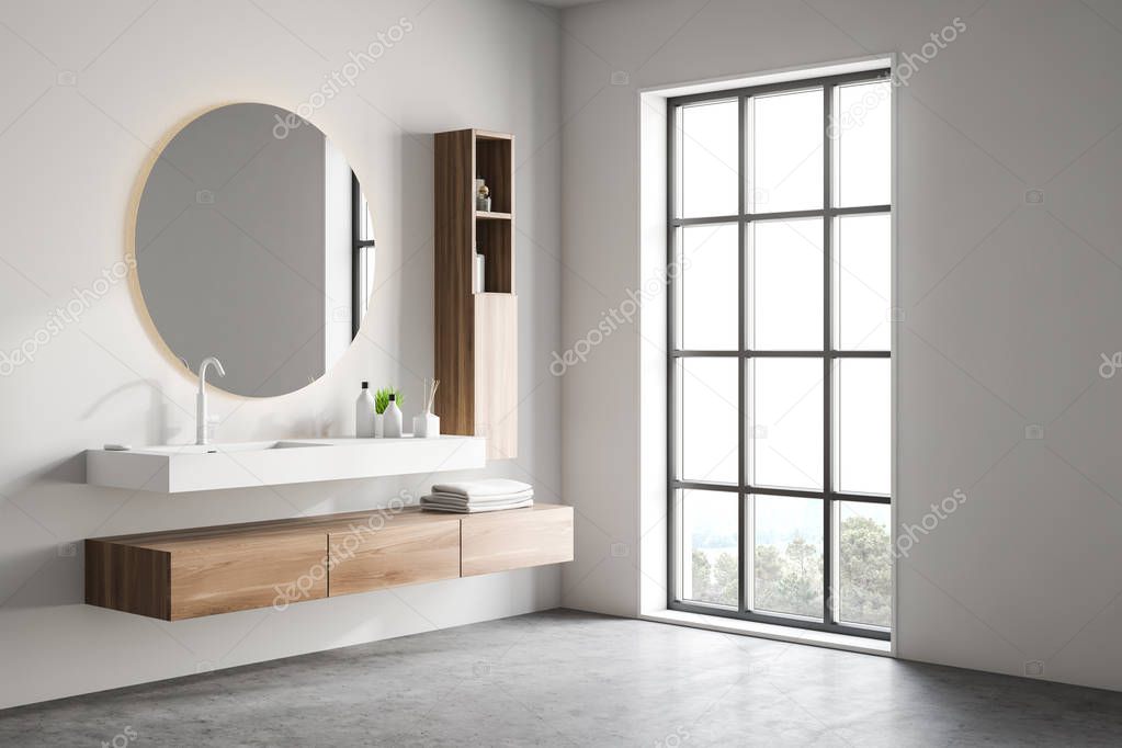 White bathroom corner with sink and mirror