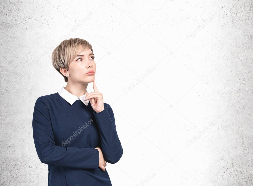 Thoughtful blonde businesswoman, mock up wall