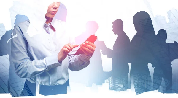 Woman with smartphone and her business team — Stock Photo, Image